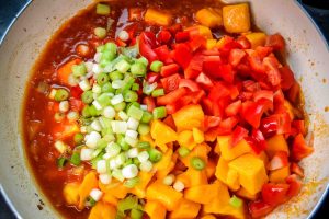 Kürbiswürfel, Paprika, und Lauchzwiebel braten